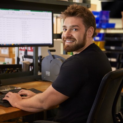 Christian Perrotta, principal and licensed customs broker, at the desk