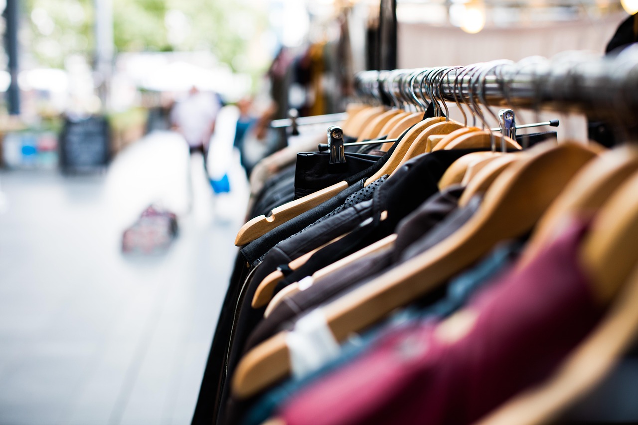 Garments hanging on a wooden rack