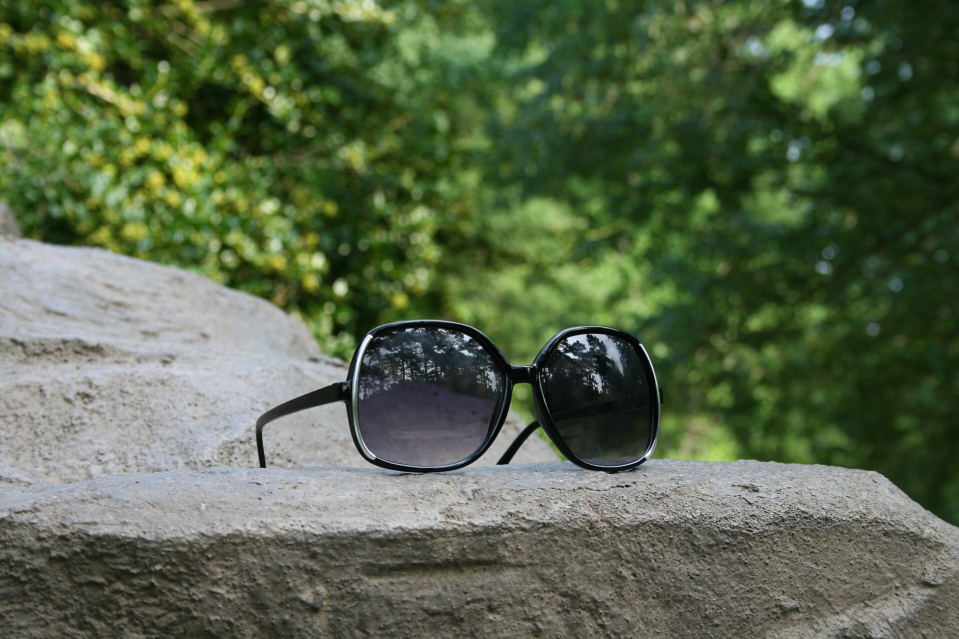 Dark sunglasses on a white ground