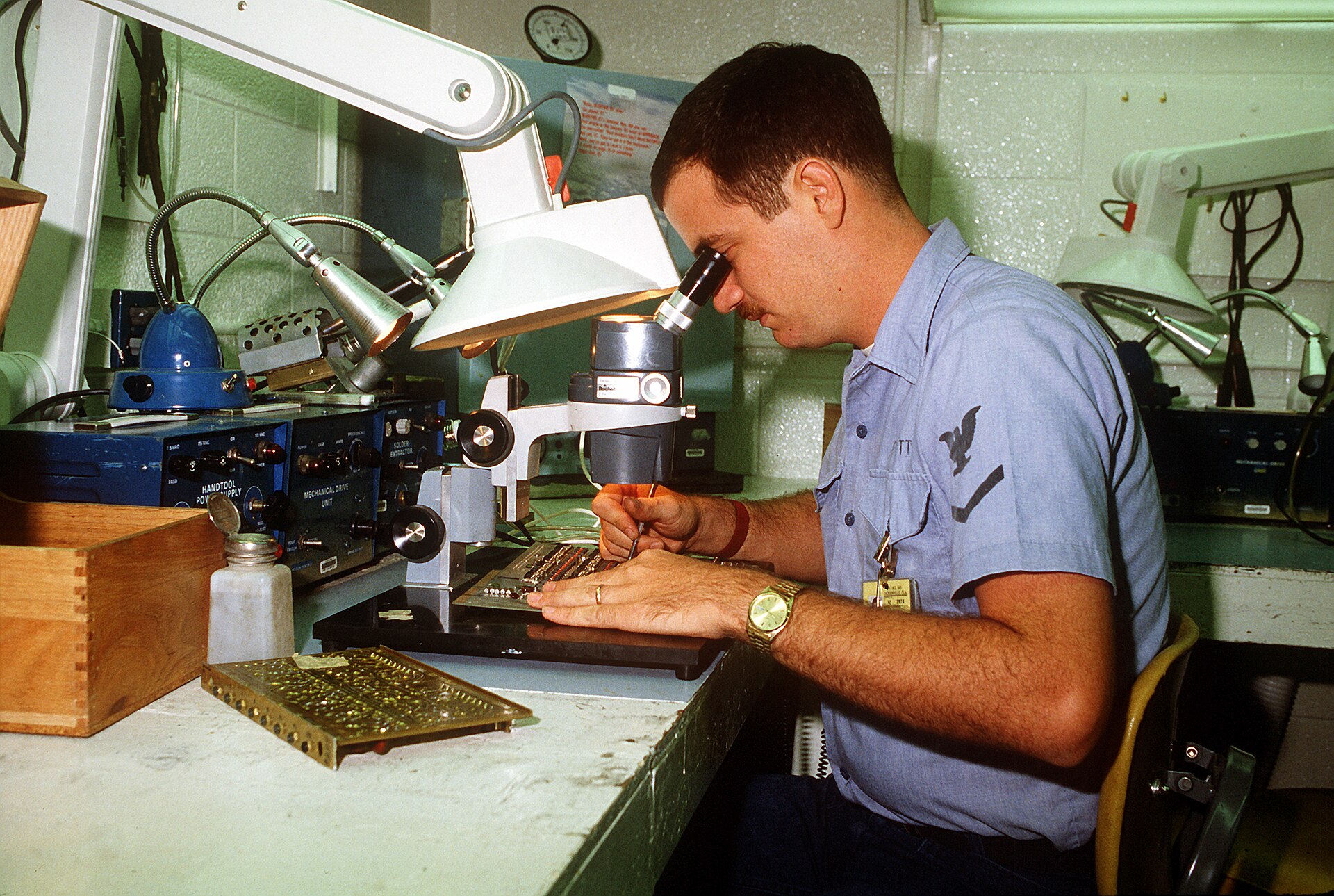 Technician inspecting a printed circuit board