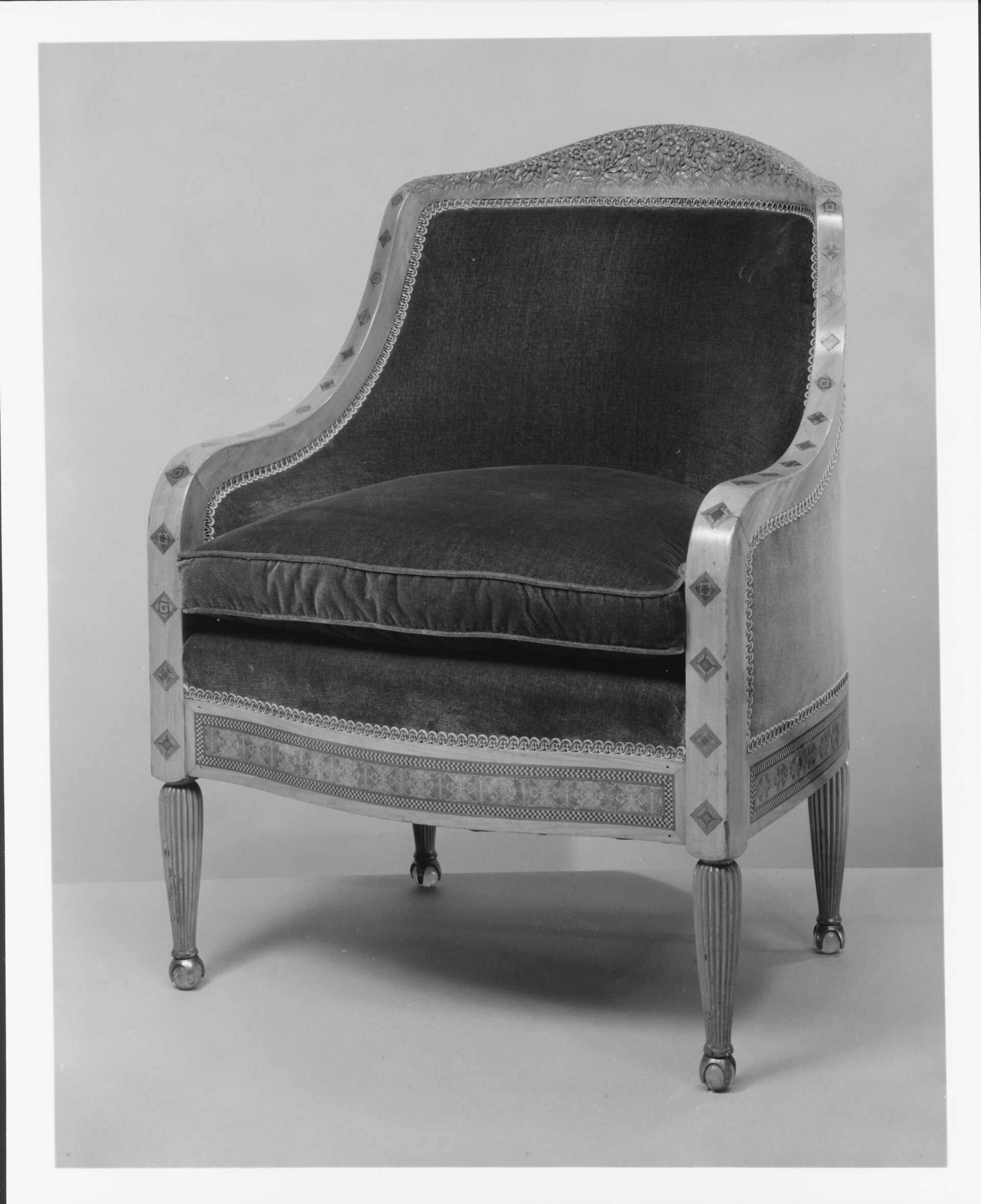 Upholstered wooden armchair on a studio ground