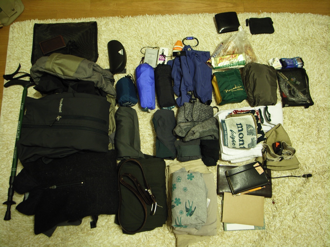 Climbing hardware and textile gear laid out for a mountain ascent