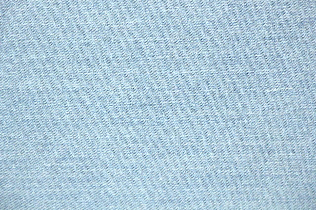 Close weave of blue denim, warp and weft visible