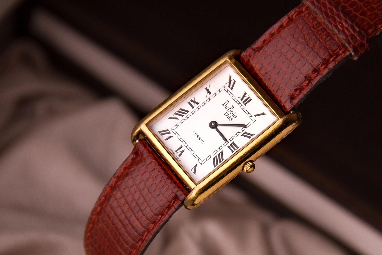 Gold tank watch with a lizard strap